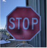 detail from table 2 from "Robust physical world attacks on deep learning visual classification" showing a photograph of a fake stop sign printed by the research team